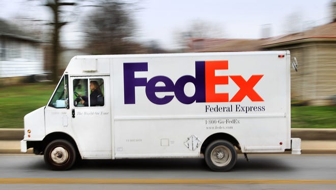 A FedEx truck makes a delivery run.