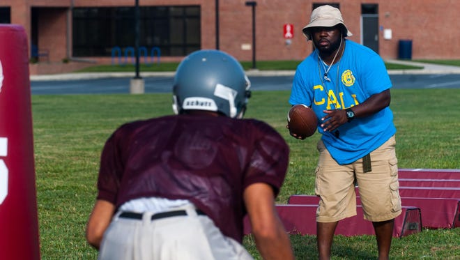 Snow Hill head coach Timothy Richo works with his running backs during a 2015 practice.