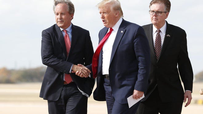 Texas Attorney General Ken Paxton, left, shown greeting President Donald Trump at Austin-Bergstrom International Airport in November, filed a legal brief opposing a Democratic effort to remove three Green Party candidates from the ballot. Lt. Gov. Dan Patrick is on the right.