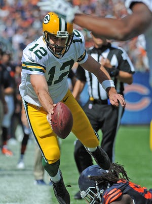 Green Bay Packers quarterback Aaron Rodgers (18) stretches for yardage on a fourth quarter scramble against the Chicago Bears at Soldier Field.