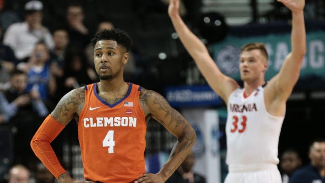 Clemson Tigers guard Shelton Mitchell (4) reacts against Virginia Cavaliers center Jack Salt (33) during the second half of a semifinals game of the 2018 ACC Tournament at Barclays Center Saturday night in Brooklyn, N.Y.
