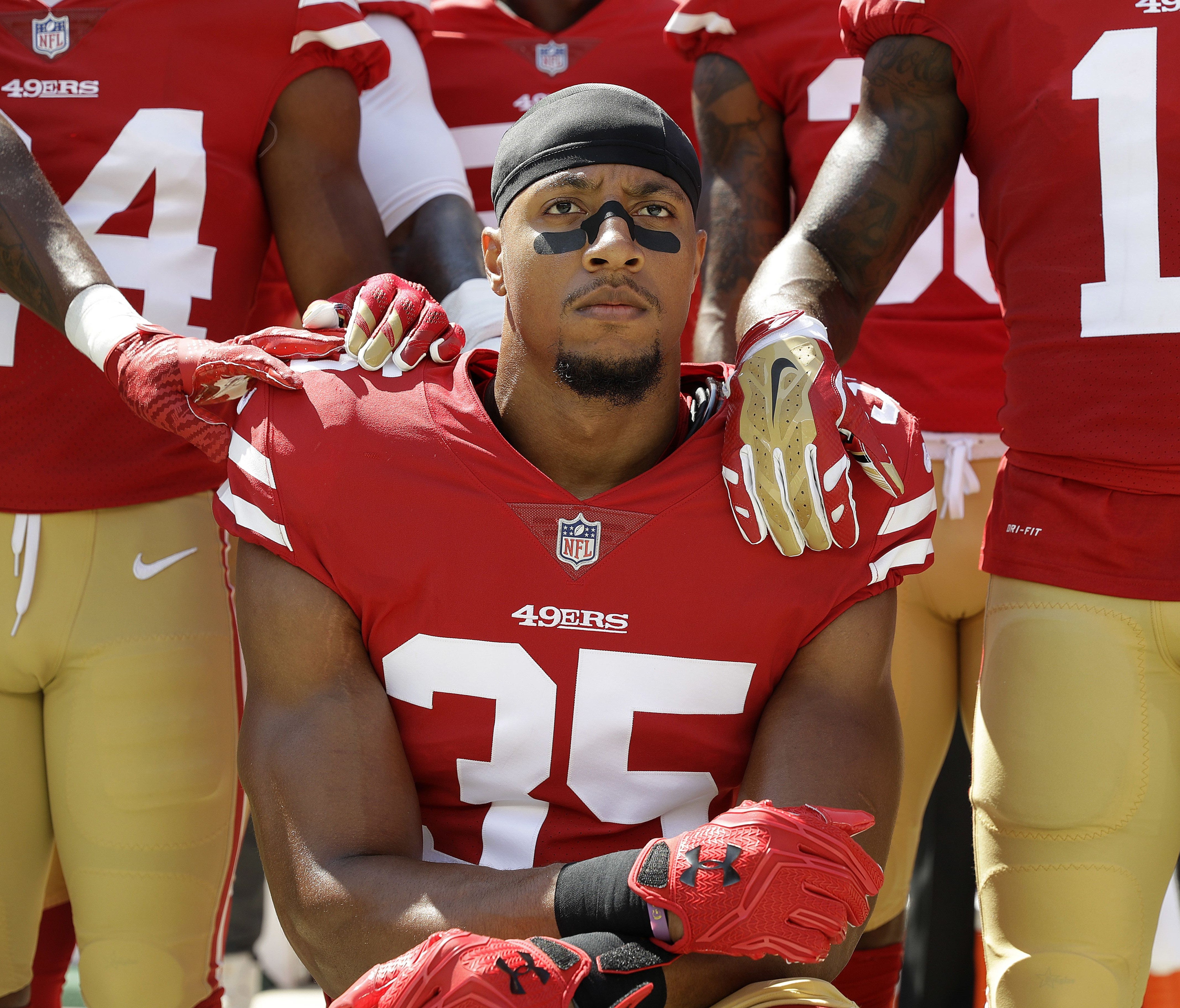 San Francisco 49ers safety Eric Reid (35) kneels in front of teammates during the playing of the national anthem before an NFL football game between the 49ers and the Carolina Panthers in Santa Clara, Calif., Sunday, Sept. 10, 2017.