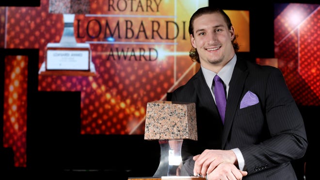 Ohio State's Joey Bosa poses with the Rotary Lombardi Award trophy Wednesday, Dec. 9, 2015, in Houston.