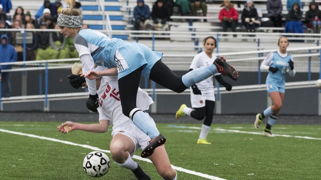 South Burlington's Posie Nash-Gibney (5) collides with CVU's Sierra Morton (15) during the high school girls soccer playoff game between the Champlain Valley Union Redhawks and the South Burlington Rebels on Saturday afternoon.