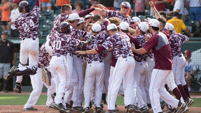 The Missouri State baseball team celebrates Jeremy Eierman's walk-off home run during the Bears game against Oklahoma State University in the NCAA Regional at Baum Stadium in Fayetteville, Ark. on Friday, June 2, 2017.