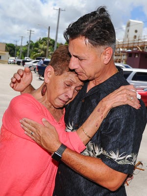 Walter Denton, right, tries to comfort Doris Concepcion, mother of Joseph Quinata, as she recalls the last words from her dying son, which ere to informed her that he was sexually molested by Archbishop Anthony Apuron. The two talked, in Agat on June 9, before a prayer vigil was held just outside the building that formerly served as the priest's residence. Denton claims that he was sexually abused, in the same building, by then-Father Anthony Apuron when he served as an altar boy at the Agat Church.
