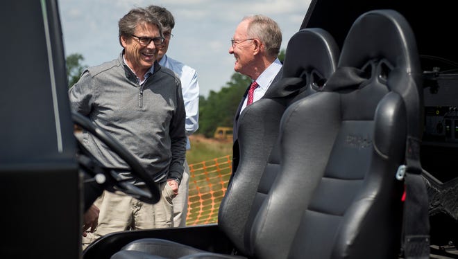 Secretary of Department of Energy Rick Perry, left, and U.S. Sen. Lamar Alexander, right, view different 3D-printed vehicles during a tour of Oak Ridge National Laboratory's Manufacturing Demonstration Facility on Monday, May 22, 2017. 