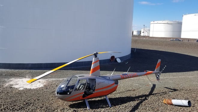 Two uninjured people in a helicopter were forced to make an emergency landing earlier today on top of a Linden refinery.