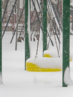 Snow covers the swing sets at Southeast Elementary, closed with all the other area schools Thursday due to the winter storm.