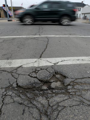 Cracks and holes in the asphalt Wednesday, Jan. 27, 2016 at the intersection of S. A and 8th Streets in Richmond.