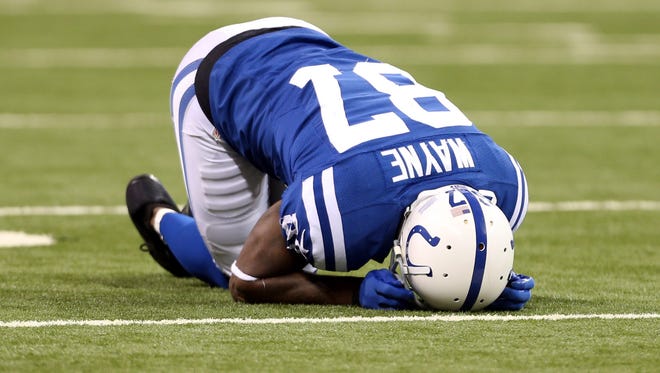 Indianapolis Colts wide receiver Reggie Wayne (87) reacts after sustaining a knee injury against the Denver Broncos at Lucas Oil Stadium in Indianapolis on Oct. 20, 2013.
