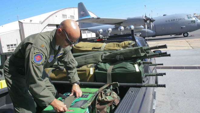 Maj. Ben Meadows loads up some equipment prior to a 2010 training mission.