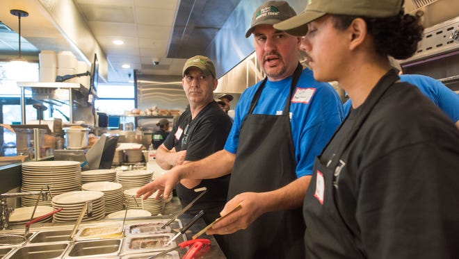 Board station trainer Joe McTiernan, center, teaches Marty Freeman, left, and Carlos Piña during training at Metro Diner in North Naples on Tuesday, Jan. 24, 2017.
