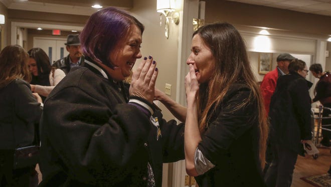 Angel Mott, right, received a surprise visit from a new friend during the visitation service for Mott's mother,