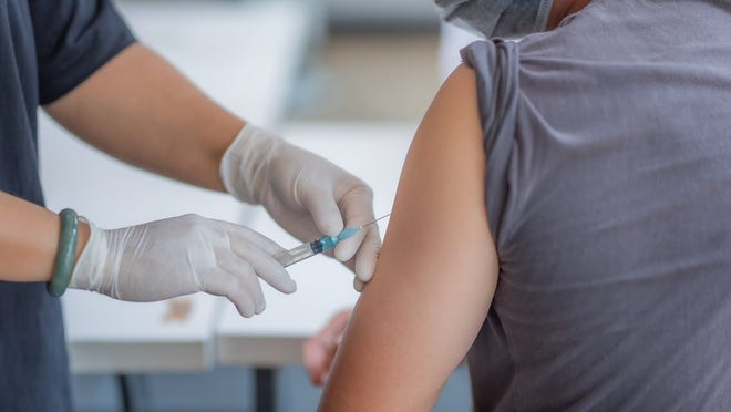 Healthcare worker administering a vaccine injection