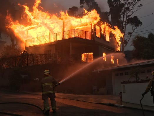 A home in Ventura goes up in flames as the Thomas Fire