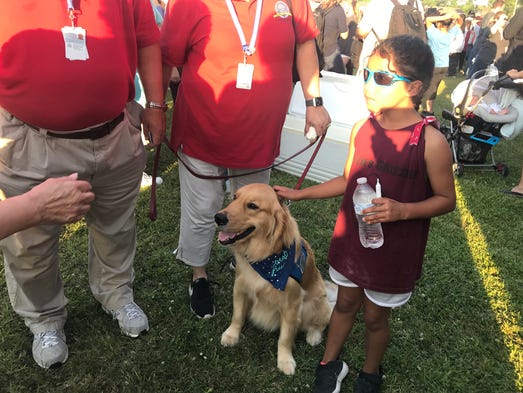 Gabriel, a trained comfort dog from Houston, receives