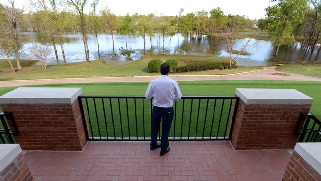 Jason Khaner General Manager at Southern Trace Country CLub looks out onto the flooded course behind the clubhouse.