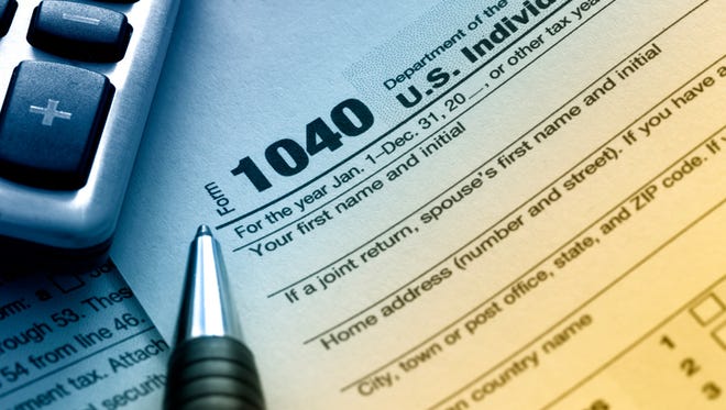 US tax form 1040 with pen and calculator.