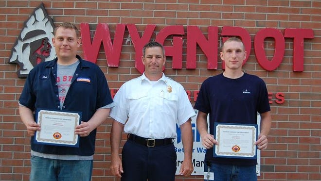 Joshua Hoskins, at left, and Drew Medley, at right, were honored for their lifesaving efforts by Madison Township Fire Department.