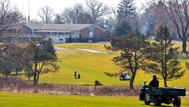 A golfer practices at the Newark Country Club clubhouse. Newark’s City Council is considering rules to limiting the club’s ability to develop the 120-acre parcel. Club officials say the proposed rules unfairly devalue the property.