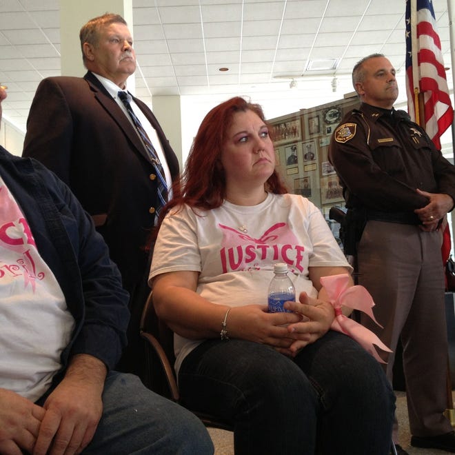 April Millsap's stepfather, David Lichtenfelt, and mother, Jennifer Millsap, listen as authorities announce charges in the July 24, 2014 death of April, 14, of Armada during a news conference Oct. 8, 2014 in the Macomb County Administration Building in downtown Mt. Clemens.