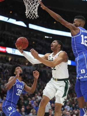 Michigan State's Miles Bridges scores against Duke's Javin DeLaurier during the first half on Tuesday, Nov. 14, 2017, in Chicago.