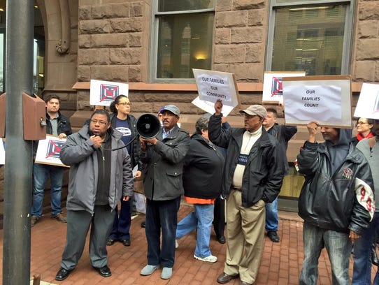 City Councilman Michael Patterson, left, joins taxi