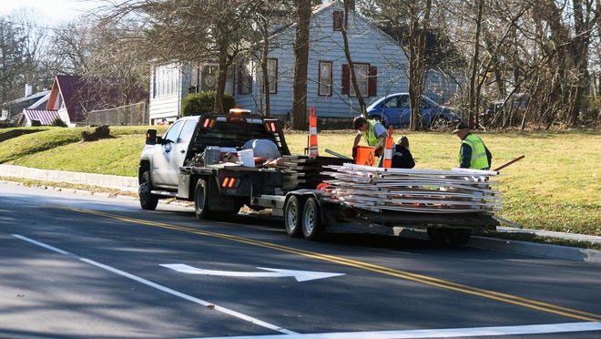 A crew removes some of the signs and barricades that were put in place for the Thornton Street project.