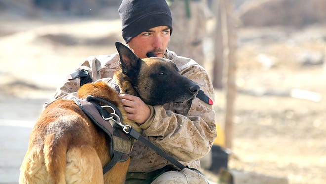 Cpl. Derrick Magee, 21, dog handler with 2nd Battalion, 4th Marines, from Vineland and his dog, TTroy, rest during a patrol break.