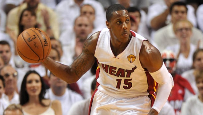 Heat guard Mario Chalmers brings the ball up the court against the Spurs during Game 3 of the 2014 NBA Finals at American Airlines Arena.