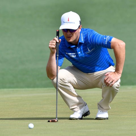 Zach Johnson lines up a putt on the 2nd green...