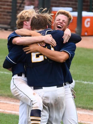 Saline’s baseball team, including Sean O’Keefe (back to camera), celebrate after defeating Northville in the Division 1 championship game.