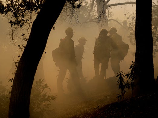 Firefighters from Kern County, Calif., work to put
