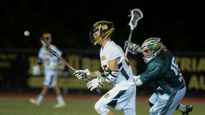 Merritt Island player Austin Howe (35) is pursued by Asa Anderson of Viera during Wednesday's game. 