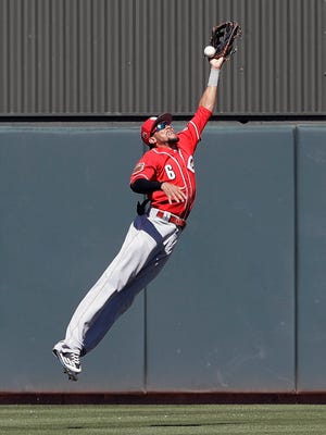 Cincinnati Reds' Billy Hamilton leaps but cannot make a catch on a ball hit by Oakland Athletics' Stephen Vogt during the second inning of a spring training baseball game Thursday, March 9, 2017, in Mesa, Ariz. (AP Photo/Darron Cummings)