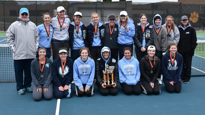 Livonia Stevenson's varsity girls tennis team celebrates winning the city championship after a 7-2 win over Livonia Churchill.