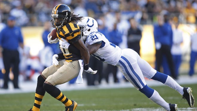 Pittsburgh Steelers wide receiver Markus Wheaton (11) runs after a reception against Indianapolis Colts cornerback Vontae Davis (21) during the first quarter at Heinz Field. Mandatory Credit: Charles LeClaire-USA TODAY Sports