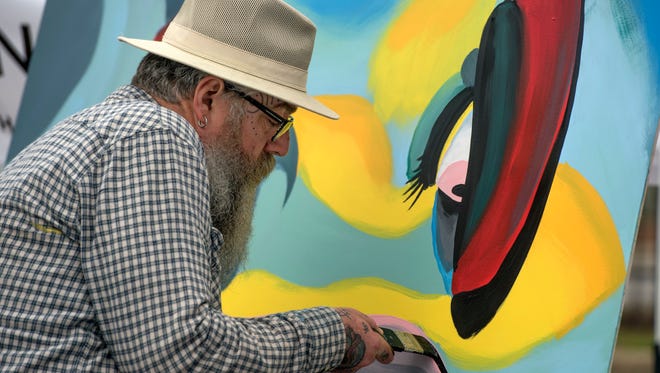 "Famous Gabe" works on a painting during a past Gulf Breeze Celebrates the Arts Festival. This year's festival takes place Saturday and Sunday.