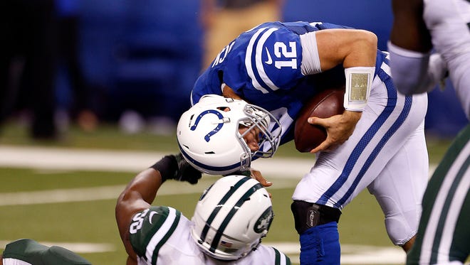 Sep 21, 2015; Indianapolis, IN, USA;  Indianapolis Colts quarterback Andrew Luck (12) is sacked by New York Jets player Quinton Coples (98). Coples was called for a penalty on the play. New York Jets defeat the Indianapolis Colts 20-7. Mandatory Credit: Brian Spurlock-USA TODAY Sports