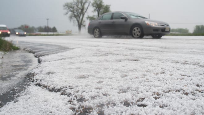 Pea-sized hail covers E. Mulberry St. after thunderstorms moved through the area Saturday, May 7, 2016. 