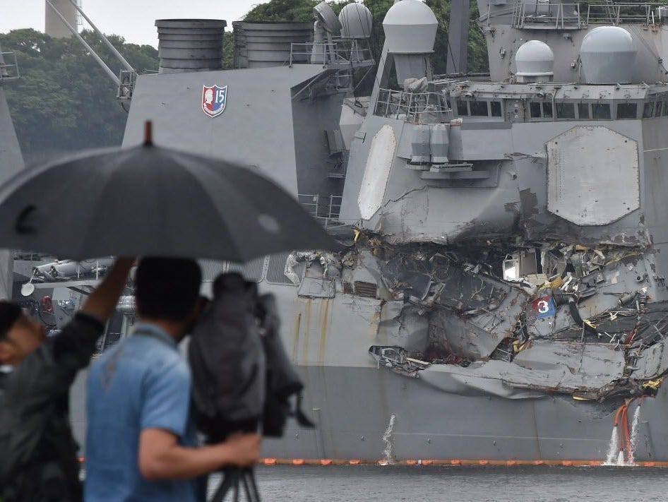 A TV crew films the damages on the guided missile destroyer USS Fitzgerald at its mother port in Yokosuka, southwest of Tokyo on June 18, 2017.