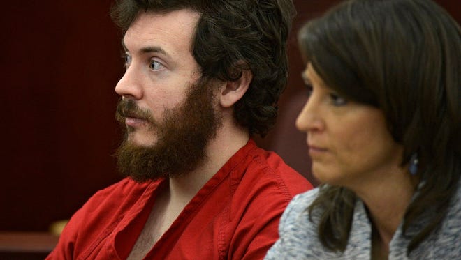 James Holmes, left, and defense attorney Tamara Brady appear in district court in Centennial, Colo., for his arraignment March 12, 2013.