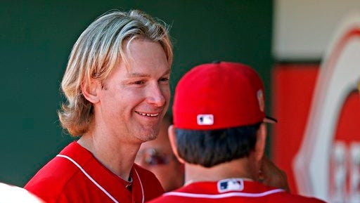 Cincinnati Reds starting pitcher Bronson Arroyo, left, smiles as he talks with pitching coach Mack Jenkins after Arroyo pitched two scoreless innings of a spring training baseball game against the Milwaukee Brewers, Sunday, March 12, 2017, in Goodyear, Ariz. (AP Photo/Ross D. Franklin)