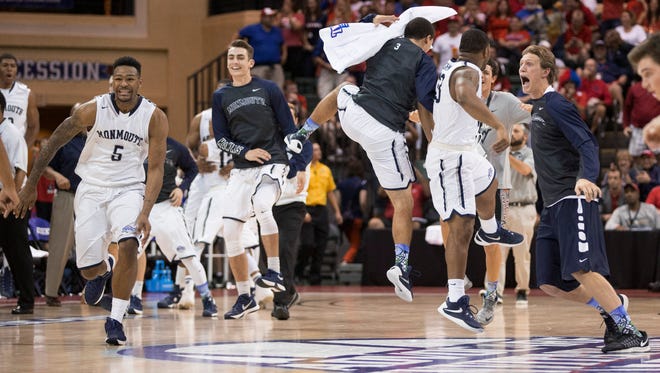 Monmouth players celebrate a 70-68 win over Notre Dame in an NCAA college basketball game Thursday, Nov. 26, 2015, in Orlando, Fla. (AP Photo/Willie J. Allen Jr.)