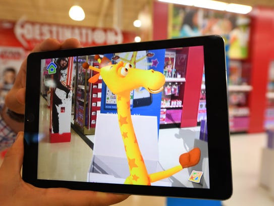 An exclusive peek at the toy store's new augmented reality in-store experience.  The experience will allow shoppers, through their mobile devices, to be guided to experience zones in the store by the chain's mascot Geoffrey. It's another example of the innovations retailers are introducing to entice shoppers to push away from the keyboard, and visit an actual store. -- Photo by Robert Deutsch, USA TODAY