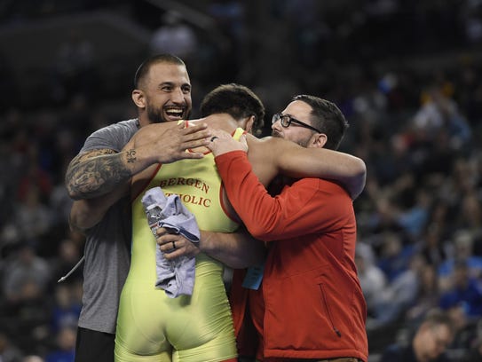 Bergen Catholic's Jacob Cardenas hugs his coaches after