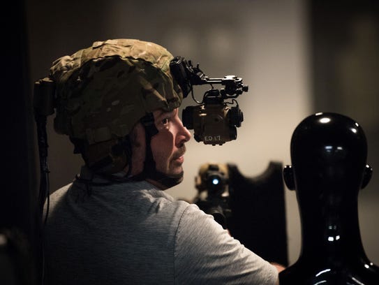 Mike Moore, a range manager at Fort Belvoir, Va., demonstrates the latest night vision goggles in a special indoor range where soldiers can use a smoke machine to obscure targets.