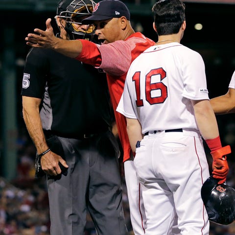 Boston Red Sox manager Alex Cora argues with home...