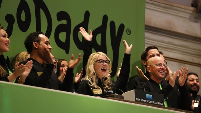 GoDaddy CEO Blake Irving (front right) claps at the opening bell on the floor of the New York Stock Exchange on Wednesday as the Scottsdale-based website-hosting service makes its initial public offering on April 1, 2015.